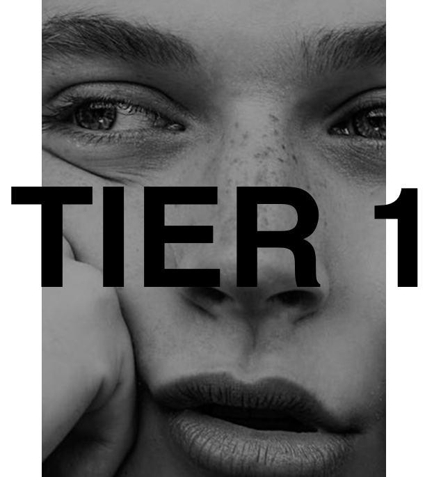 Tier 1 skin subscription at Ashleigh Hasson, a non-surgical skin aesthetics studio in Darling Point, Sydney—black and white portrait of a freckled woman with bushy eyebrows, full lips, and a playful expression as she squishes her face. "Tier 1" displayed in bold black capital letters across the image.